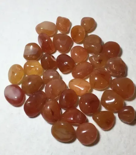 Imagen de Piedras semi preciosas Cornalina rolada piedras de 1.5 a 2cms. en paquete de 100grs.
