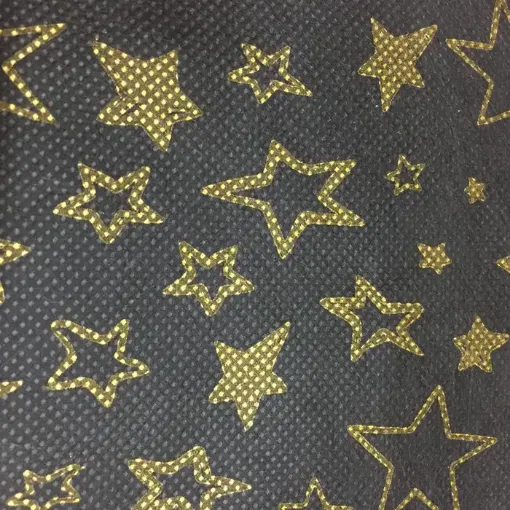 Imagen de Tnt estampado para manualidades de 100x140cms modelo estrellas doradas con fondo negro