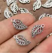 dije colgante metalico modelo pluma medida 8x15mms x20 unidades color plata antiguo 1